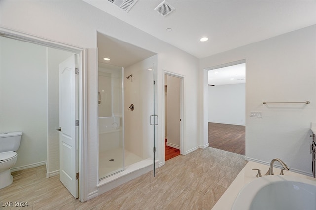 bathroom featuring independent shower and bath, toilet, and wood-type flooring