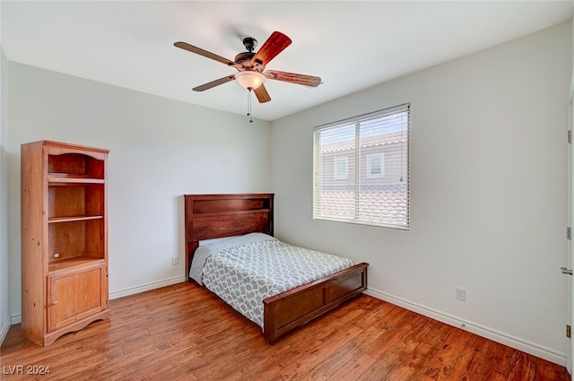 bedroom with ceiling fan and hardwood / wood-style flooring