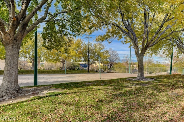 view of property's community with a yard and volleyball court