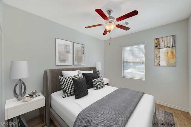 bedroom with light wood-type flooring and ceiling fan