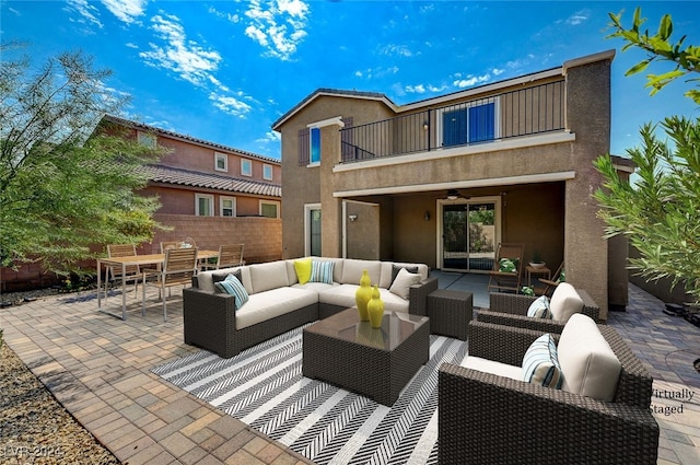 view of patio / terrace featuring a balcony, an outdoor living space, and ceiling fan