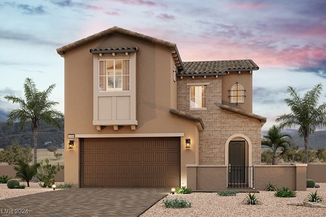 mediterranean / spanish-style house with a garage