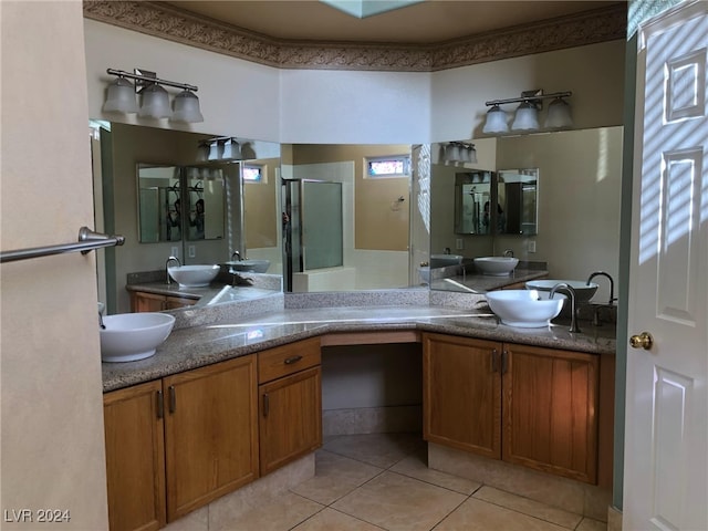 bathroom featuring walk in shower, tile patterned flooring, and vanity