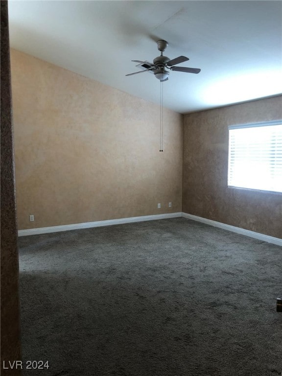 spare room featuring ceiling fan and carpet floors