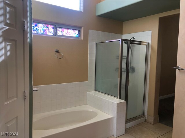 bathroom with tile patterned flooring and plus walk in shower