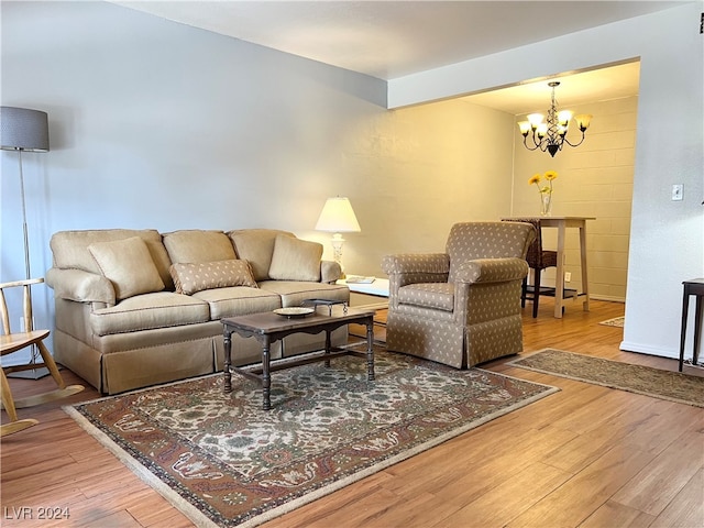 living room featuring wood-type flooring and a notable chandelier