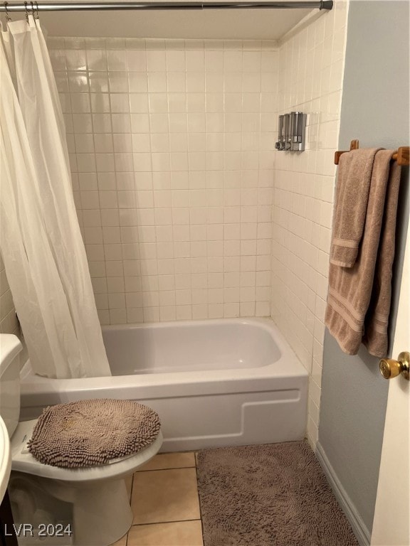 bathroom featuring shower / bath combination with curtain, toilet, and tile patterned floors