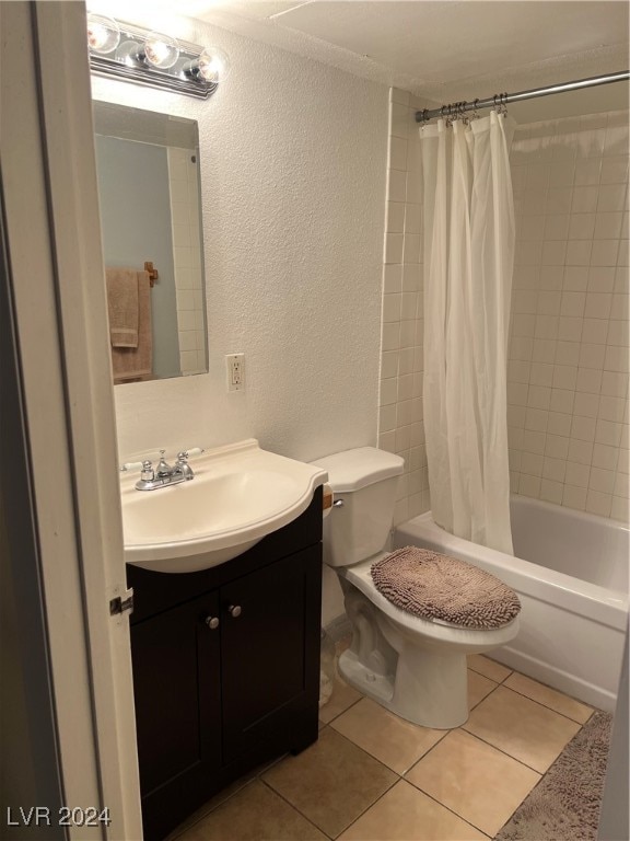 full bathroom with vanity, toilet, shower / bathtub combination with curtain, and tile patterned floors