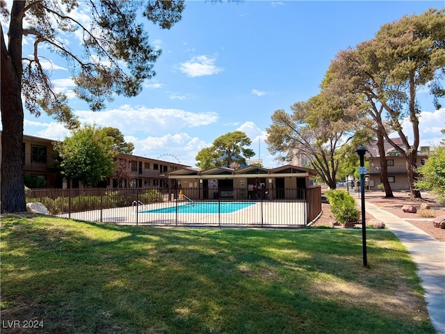 view of swimming pool featuring a yard