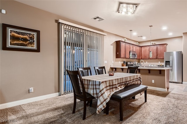 dining room featuring light colored carpet