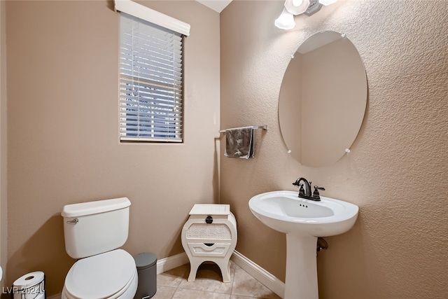 bathroom featuring toilet and tile patterned flooring