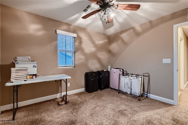 carpeted home office featuring ceiling fan