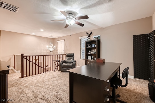 carpeted office with a textured ceiling and ceiling fan with notable chandelier