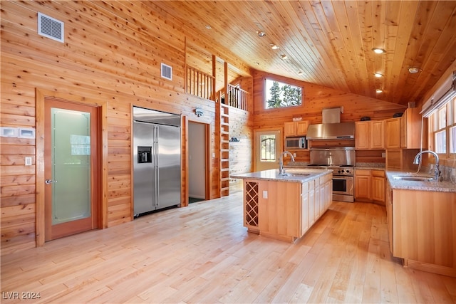 kitchen with ventilation hood, built in appliances, high vaulted ceiling, and sink