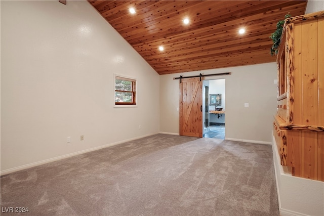 unfurnished room with a barn door, high vaulted ceiling, carpet floors, and wooden ceiling