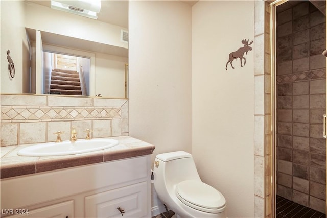 full bath featuring toilet, tasteful backsplash, a stall shower, visible vents, and vanity