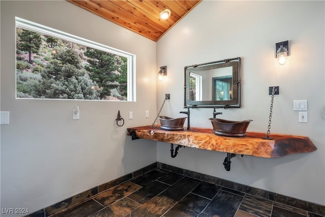 bathroom with wooden ceiling, lofted ceiling, and a healthy amount of sunlight