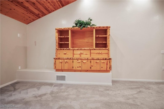 unfurnished room featuring lofted ceiling, visible vents, wooden ceiling, light carpet, and baseboards