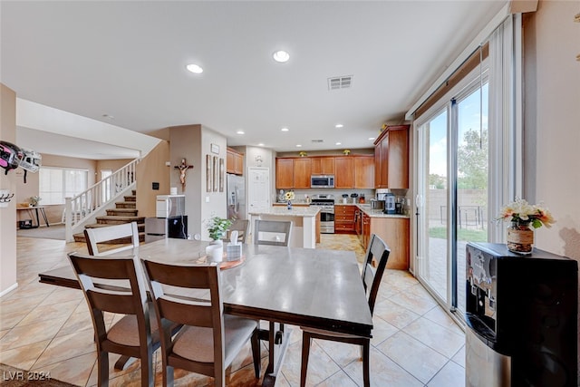 dining room featuring plenty of natural light and light tile patterned floors