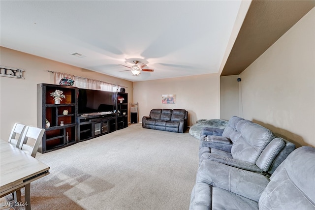 carpeted living room with ceiling fan