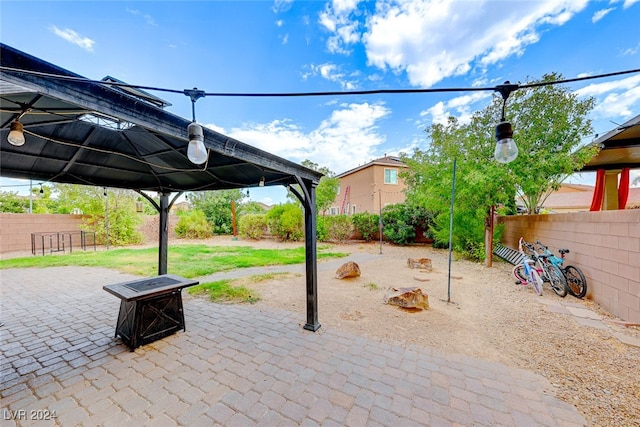 view of patio featuring a gazebo and an outdoor fire pit