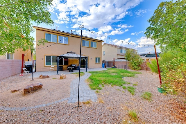 rear view of property with a gazebo and a patio area