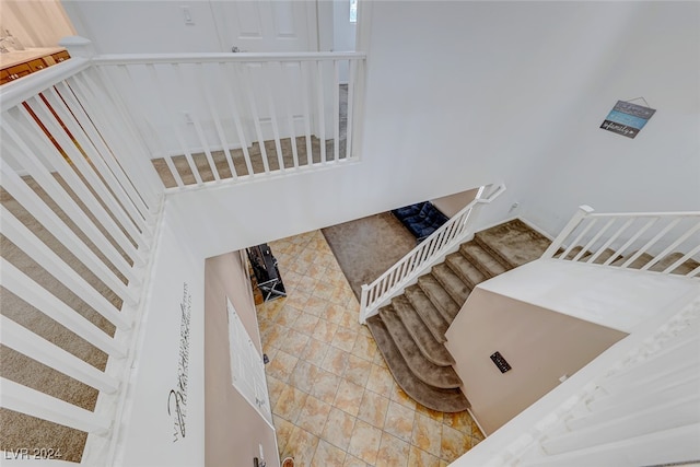 staircase featuring tile patterned flooring