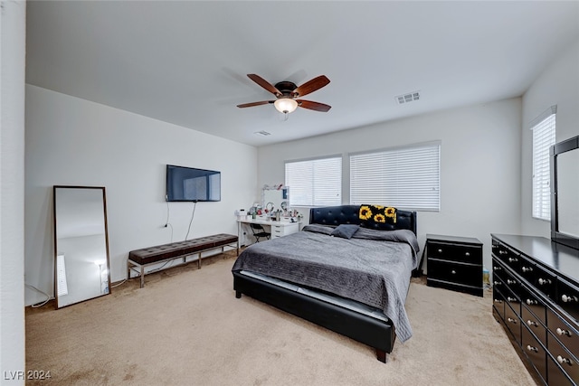 bedroom featuring light colored carpet and ceiling fan