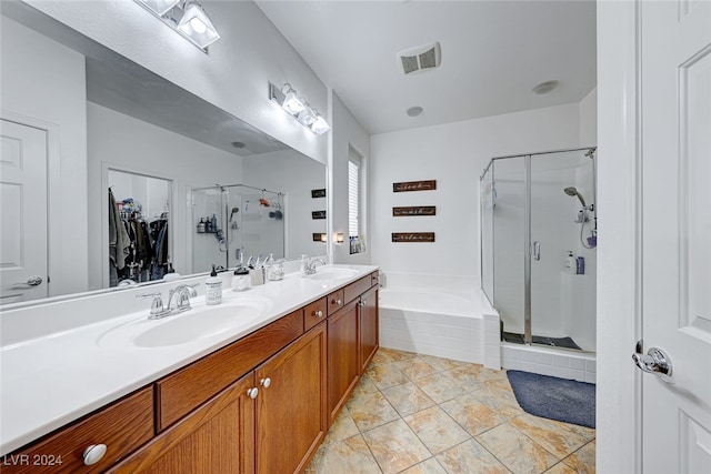 bathroom with tile patterned flooring, separate shower and tub, and vanity