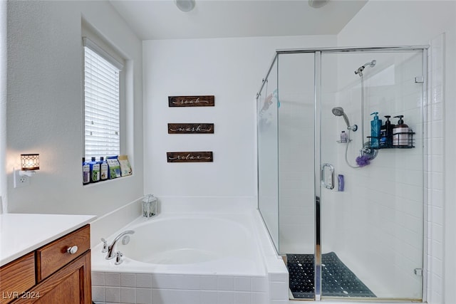 bathroom featuring vanity and shower with separate bathtub