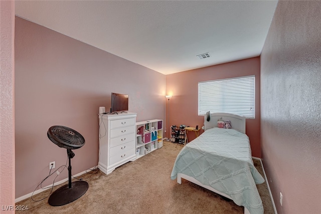 bedroom featuring light carpet