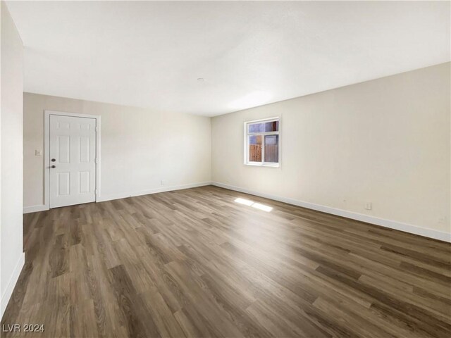 empty room with dark hardwood / wood-style floors