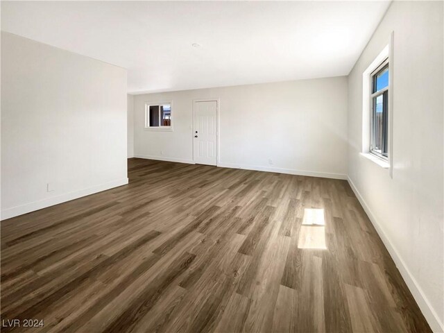 spare room with dark wood-type flooring