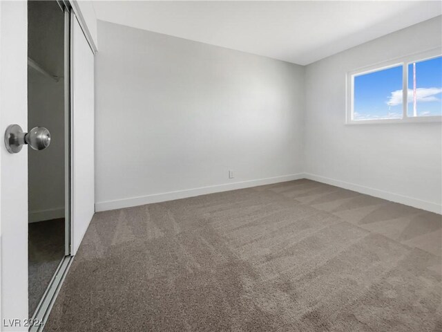 unfurnished bedroom with a closet and carpet floors