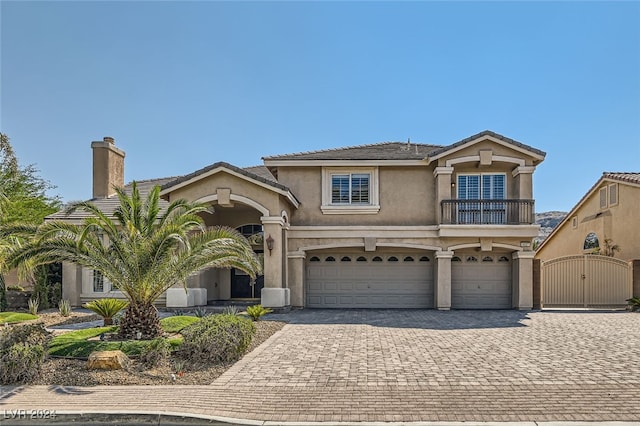 view of front of property with a balcony and a garage