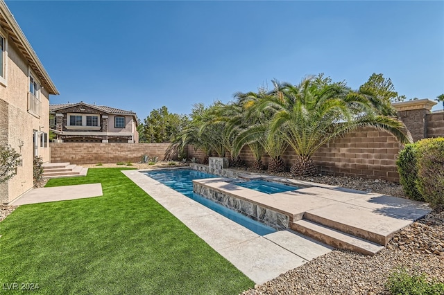 view of swimming pool featuring a lawn and an in ground hot tub