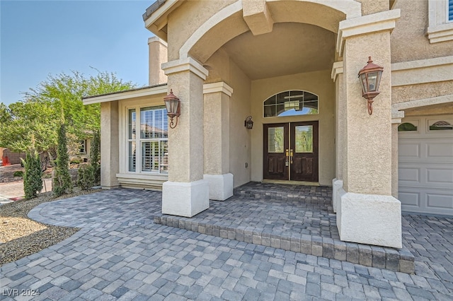 property entrance featuring french doors and a garage