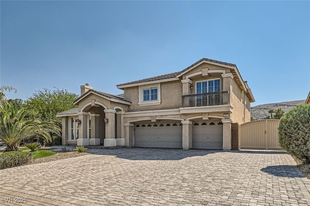 view of front of home with a balcony and a garage