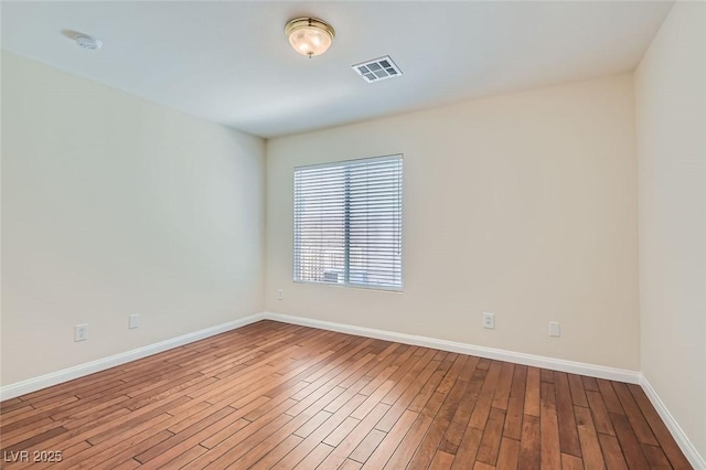 unfurnished room with light wood-type flooring