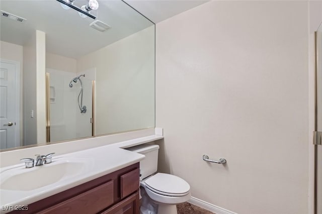 bathroom with a shower, vanity, and toilet