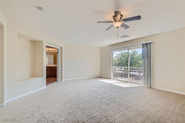 spare room with ceiling fan and carpet