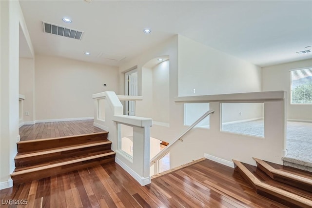 stairs featuring hardwood / wood-style flooring