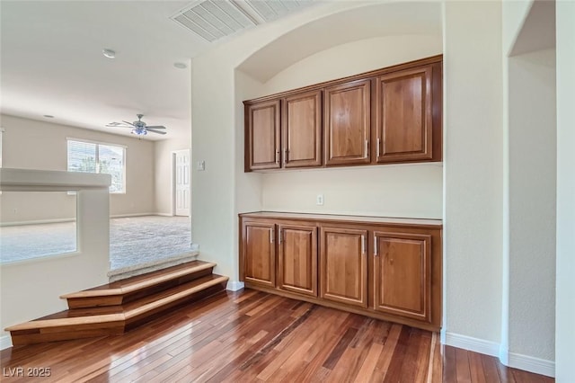 interior space featuring ceiling fan and dark wood-type flooring