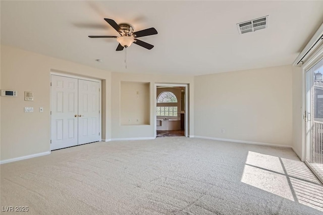 unfurnished bedroom with ceiling fan, light colored carpet, and a closet