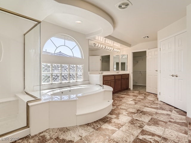 bathroom featuring shower with separate bathtub and vanity