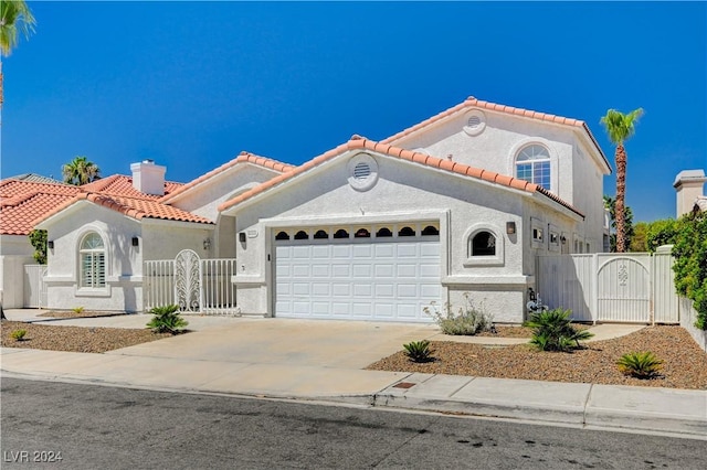 mediterranean / spanish-style home featuring a garage