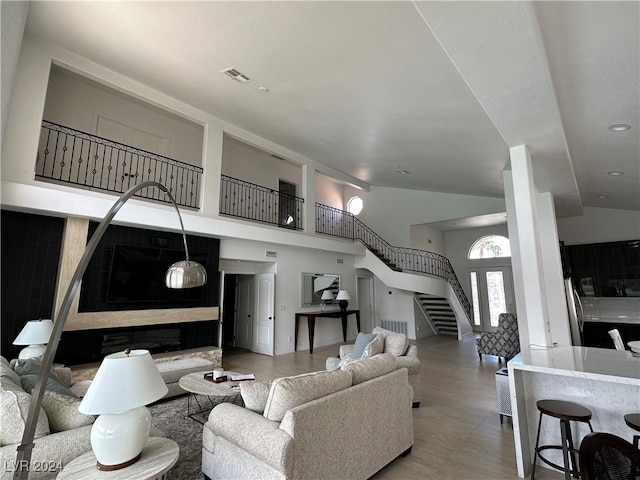 living room featuring high vaulted ceiling