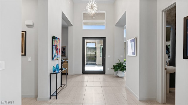 tiled foyer entrance with a towering ceiling