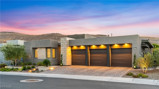 modern home with a garage and a mountain view