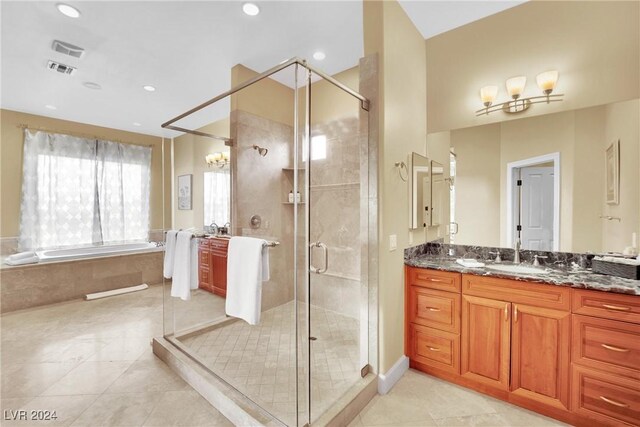 bathroom featuring tile patterned flooring, vanity, an inviting chandelier, and shower with separate bathtub